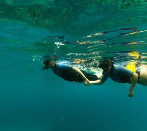 2 Persons Snorkeling by holding hands